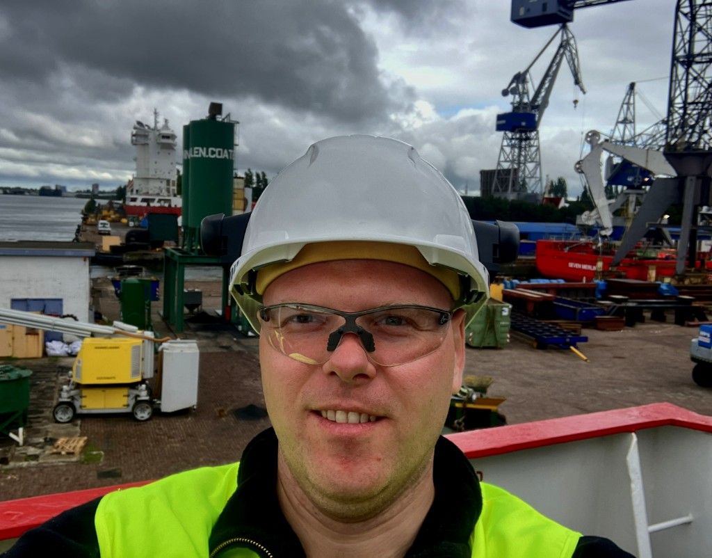 Independent Controls Engineer in marine PPE at industrial site